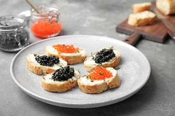 Sandwiches with black and red caviar on plate
