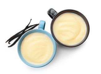 Cups with vanilla pudding on white background