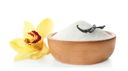 Vanilla sugar in bowl with flower and sticks on white background