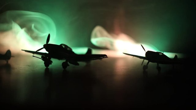 Slider shot. Retro World War 2 propelled model planes in possession.  Dark foggy light background. War scene. Useful for documentary.  Selective focus