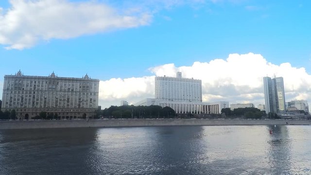 house of government and other buildings near the river timelapse