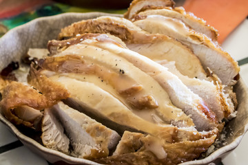 Closeup of Turkey Covered with Gravy in a Serving Dish