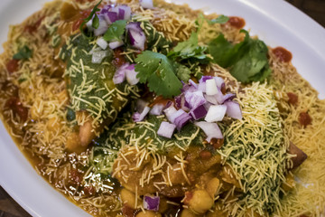 Closeup of a Colorful Samosa Chaat Indian Food Dish with Cilantro and Onions