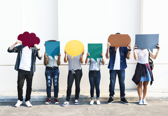 Young adult friends holding up copyspace placard thought bubbles - obrazy, fototapety, plakaty