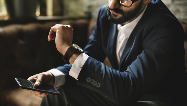 A Businessman Looking At A Watch