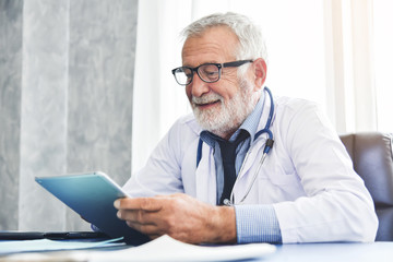 Doctor is using digital tablet computer.