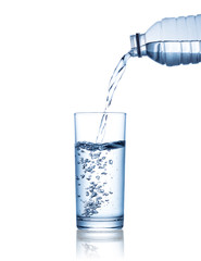 pouring water on a glass isolated on white background. Clipping path