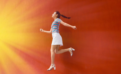 Fototapeta na wymiar young woman jumps to lights
