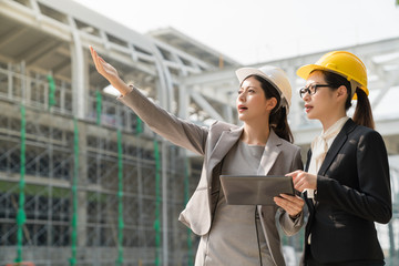 Female architect showing building project.