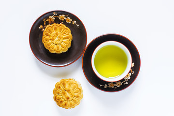 Mooncake and tea, food and drink for Chinese mid autumn festival. Isolated on white background