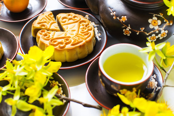 Mooncake and tea, food and drink for Chinese mid autumn festival. Isolated on white background