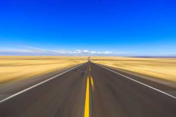 Fototapeta na wymiar Desert two lane highway with motion blur
