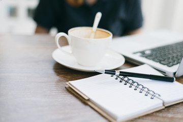 a cup of coffee latte has drank on wooden table