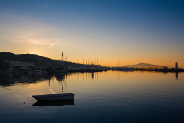 Fototapeta na wymiar A rowboat watches an amazing sunset