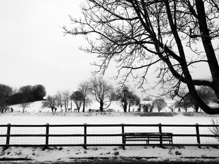 Monochrome wintry rural snow scene in mid march on farmland 