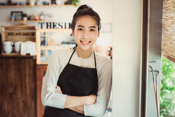 Portrait Asian woman business owner with bakery shop background