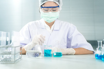 Professional distinguished Science specialist at work.Young Asian scientist with test tube making research in clinical laboratory.Innovative technologies in science and medicine