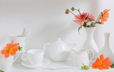 white dishvare with flowers on wooden shelf