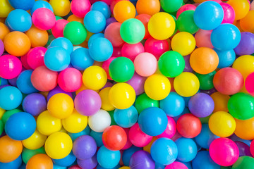 Top view of many colorful balls in ball pool at indoors playground - obrazy, fototapety, plakaty