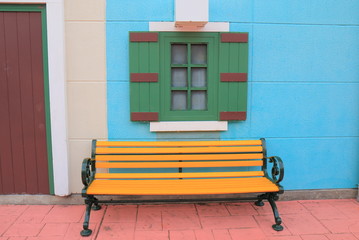 Colourful house with yellow bench