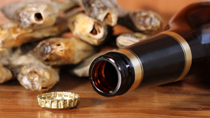 Beer bottle on a wooden table. Russian snack . Beer and dried fish.