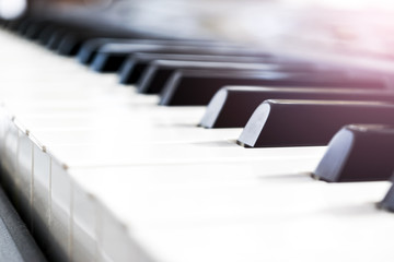 Side view of piano keys. Close-up of piano keys. Close frontal view. Piano keyboard with selective focus. Diagonal view. Piano keyboard perspective. Soft lighting