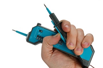 Modern compact live voltage detector with retractable test probe extended, held in left hand of electrician, white background.