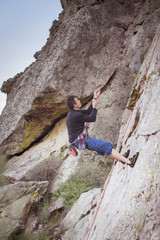 man climbing a rock wall