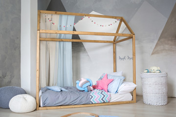 children's bed house in the interior of kid's room in the Scandinavian style