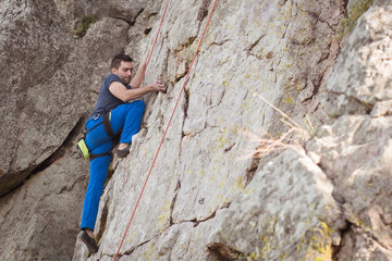 man climbing a rock wall