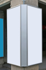 Metal vertical advertising boards are fixed on a concrete column