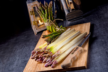 white and green asparagus on kitchen board