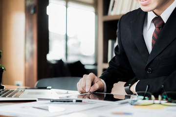 man holding credit card and using laptop and smartphone shopping website online, shopping concept