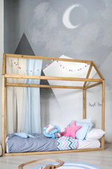 children's bed in the modern interior of kid's room in the Scandinavian style