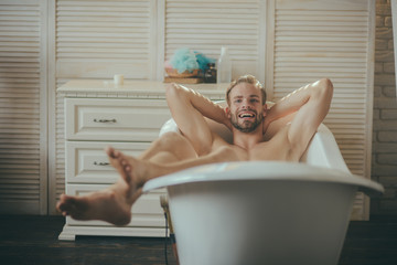 Man having joyful morning in bathtub