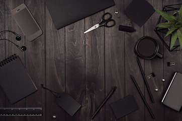 Blank black corporate stationery as work place with copy space on dark stylish wood background. Branding mock up for branding, graphic designers presentations and business portfolios. 