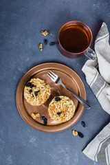 Eastern or Asian sweets (chak-chak) with honey, raisins and walnut on stone concrete table background. Copy space, top view