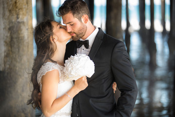 Classic well-dressed bride and groom intimate and close together after wedding vows