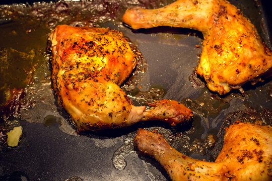 Delicious spicy baked chicken leg in the oven. Preparing food at home dinner.