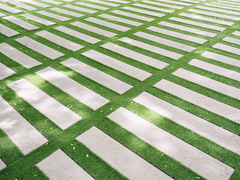 Cement Block Path Walkway On Green Grass Background