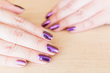 Obraz na płótnie Canvas Beautiful nail polish in hand, Purple nail art manicure, Woman's hand 