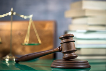 Law and Justice concept. Gavel of the judge, books, scales of justice. Brown background,  Courtroom...