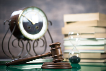 Law and Justice concept. Gavel of the judge, books, scales of justice. Brown background,  Courtroom theme.