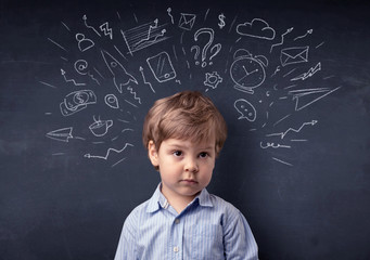 Little boy in front of a drawn up blackboard