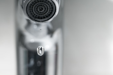 water drop on faucet, world water day concept with copy space