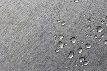 Some water drops in a corner on the metallic grey surface