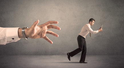 Businessman running from hand