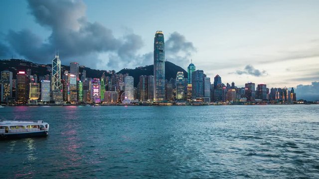 Hong Kong, China, day to night time lapse view of skyline and Victoria Harbour.