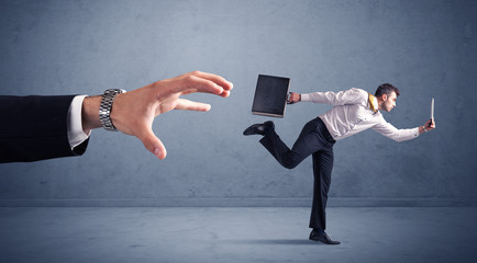 Businessman running from hand