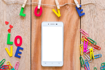 Valentine's day love Letter with Smartphone and notebook on wooden board background with copy space.